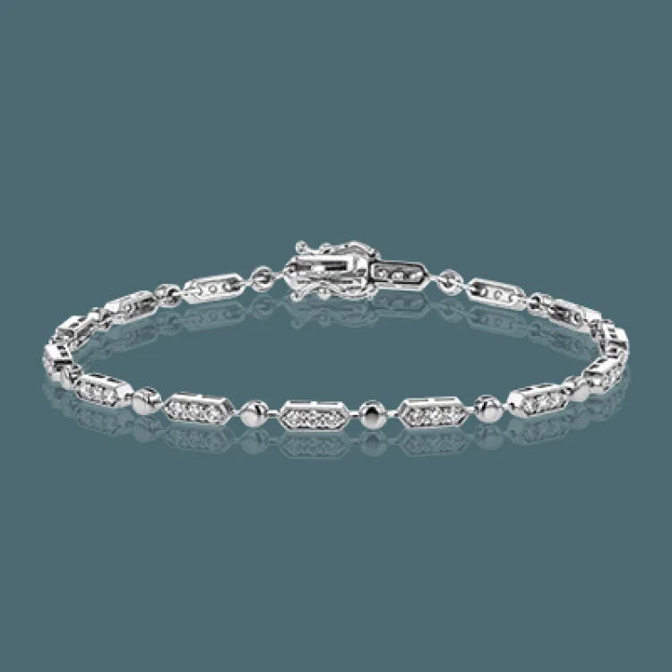 Women’s charm bracelets-The delicate, geometric design of this bracelet alternates 1.00 ctw of white diamonds set in white gold with subtle rose gold accents