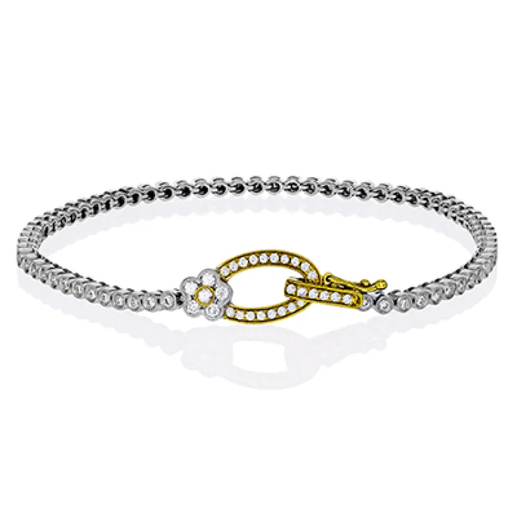 Women’s multi-strand bracelets-This two tone 18k white and rose gold buckle bracelet contains .98 ctw of white round brilliant diamonds, a .02 ct pink diamond, and a tiny flower design.