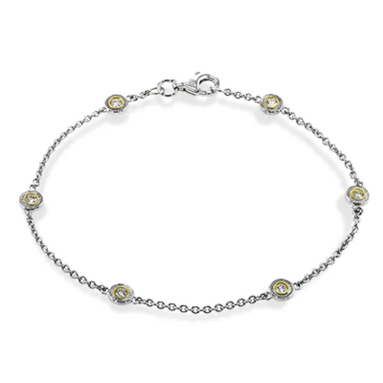 Women’s square bangles-This two-tone 18k yellow and white gold bracelet contains .24 ctw of white diamond for the perfect accent of sparkle and shine.