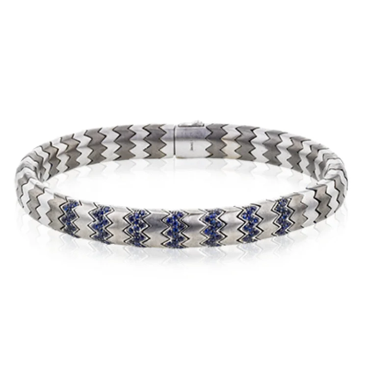 Women’s silver bangles-This men's bracelet in white gold and titanium zig zag pattern is accented by the perfect touch of 1.04 ctw of blue sapphires.