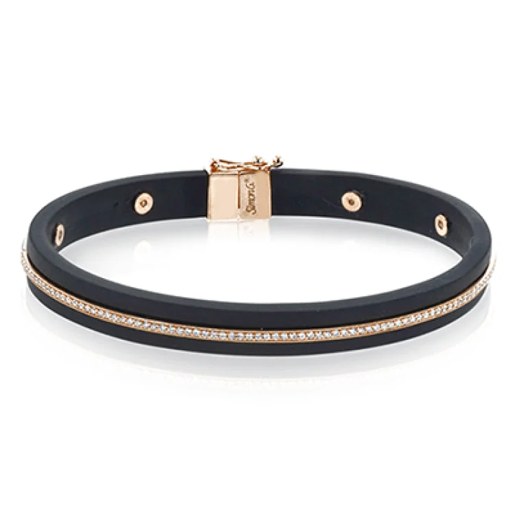 Women’s bangles-A sleek line of .39 ctw of diamonds makes a statement in this black rubber bracelet with 14k gold elements.