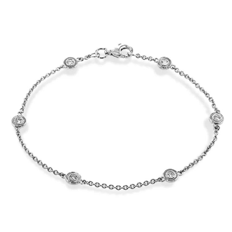 Women’s engraved bracelets-This two-tone 18k yellow and white gold bracelet contains .24 ctw of white diamond for the perfect accent of sparkle and shine.