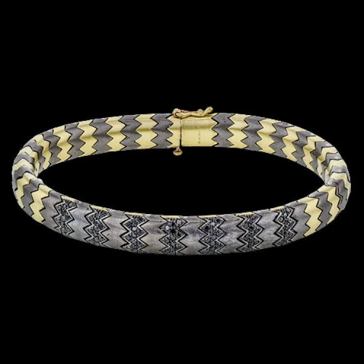 Women’s stretch bracelets-This stunning bracelet is wrought from 14k gold and titanium, and features .74 ctw of black diamonds set into its zigzag pattern.