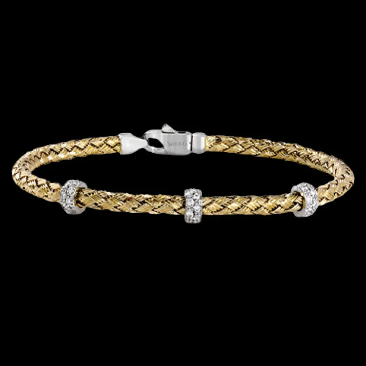 Women’s luxury bracelets-This wonderful 18k yellow gold woven bracelet contains .33 ctw of white diamonds, adding an opulent touch which can still be worn everyday. Perfect for stacking.