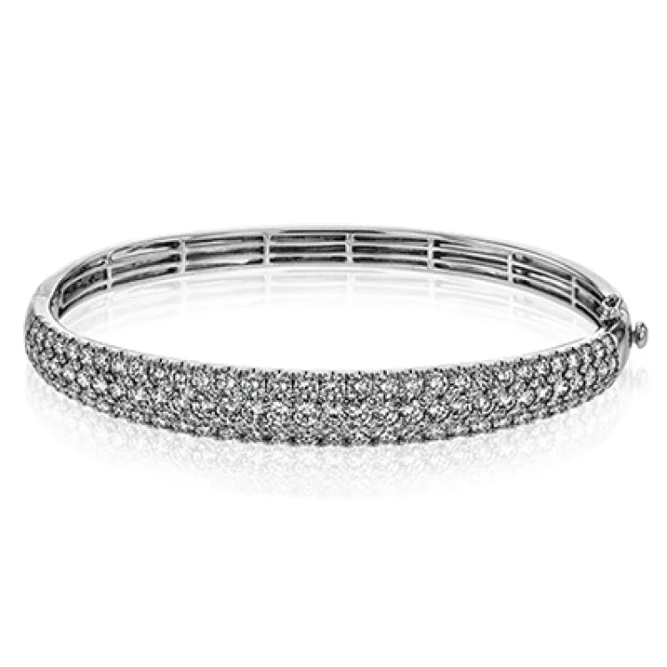 Women’s stackable bangles-This three-row 18k white gold bangle bracelet is sure to turn heads with 5.42 ctw of white diamonds.