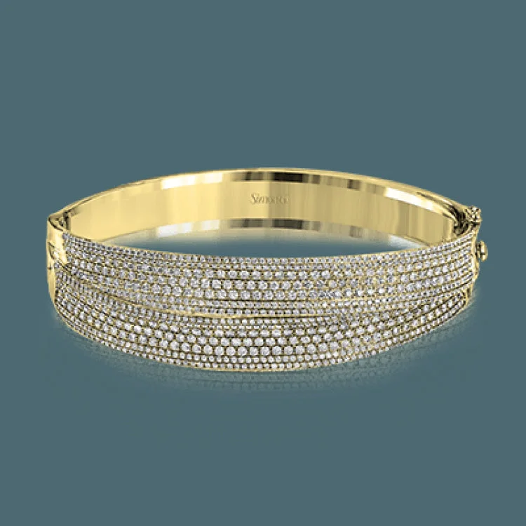 Women’s rhinestone bracelets-This striking bangle bracelet contains a stunning 4.69 ctw of white diamonds set into a 18k white and rose gold design.