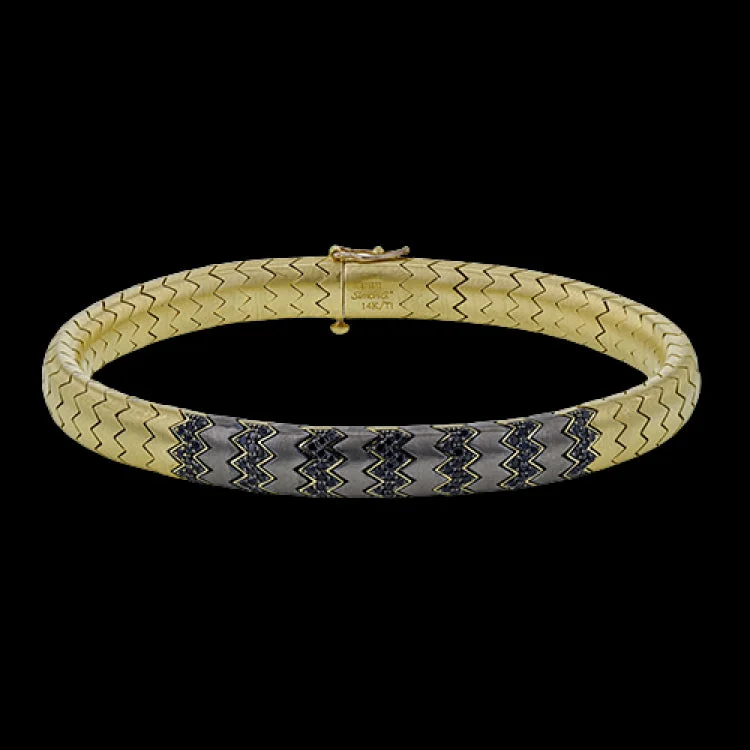 Women’s stackable bracelets-This 14k gold and titanium bracelet contains .67 ctw of black diamonds for the perfect edgy touch.