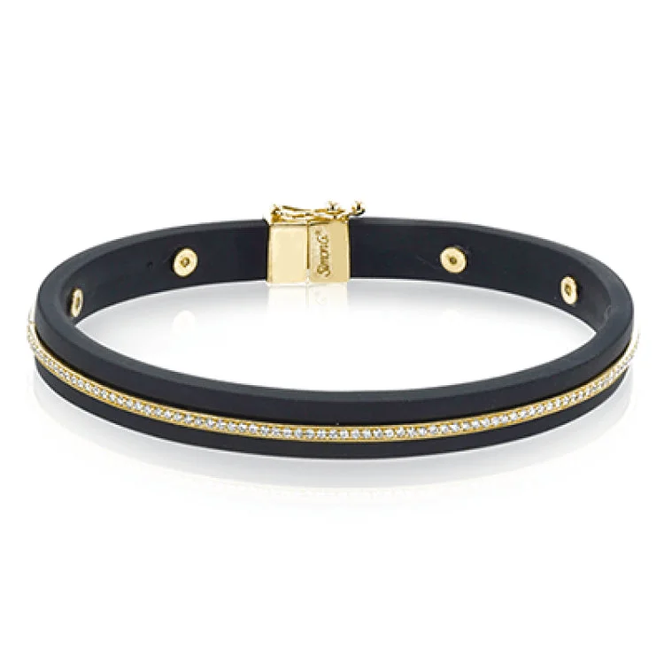 Women’s holiday bracelets-A sleek line of .39 ctw of diamonds makes a statement in this black rubber bracelet with 14k gold elements.