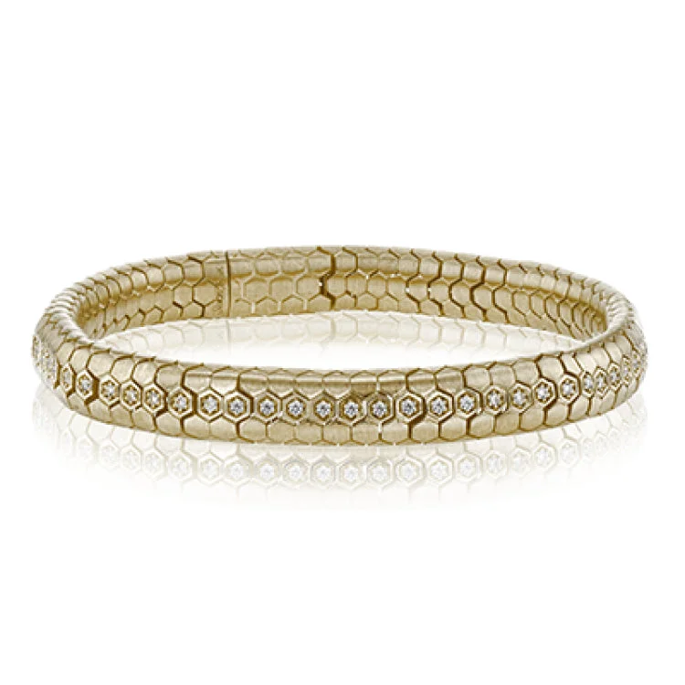 Women’s diamond bangles-This sinuous 14k gold bracelet is set with .69 ctw of white diamonds.