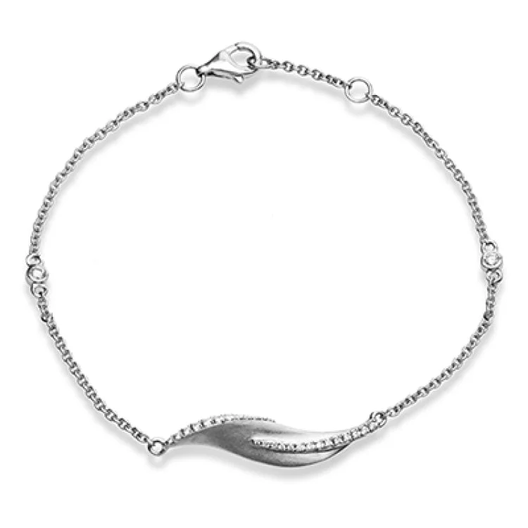 Women’s gold chain bracelets-This nature-inspired 18k white gold bracelet contains .20 ctw of diamonds in a leaf design.