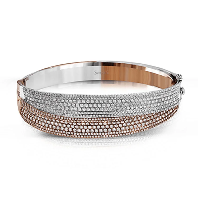 Women’s pearl stretch bracelets-This striking bangle bracelet contains a stunning 4.69 ctw of white diamonds set into a 18k white and rose gold design.