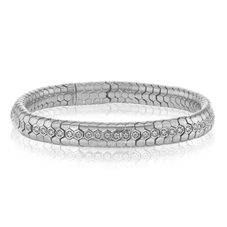 Women’s stackable bangles-This sinuous 14k gold bracelet is set with .69 ctw of white diamonds.