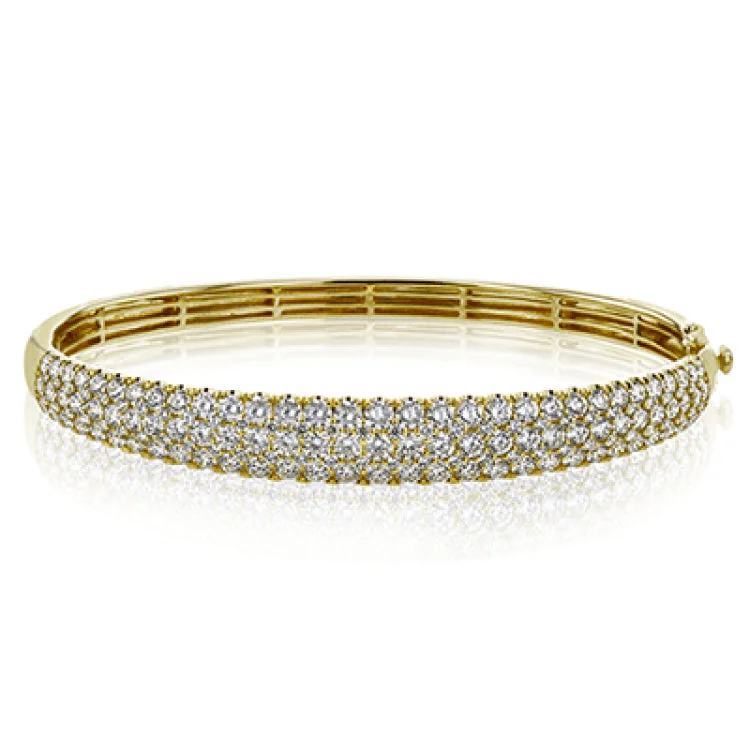 Women’s silver bracelets-This three-row 18k white gold bangle bracelet is sure to turn heads with 5.42 ctw of white diamonds.